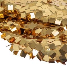 a pile of gold colored confetti sitting on top of each other