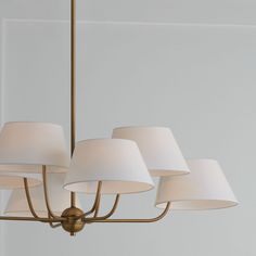 a chandelier with six white lamps hanging from it's sides and four on each side