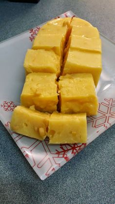 sliced pieces of cheese sitting on top of a white plate