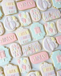 decorated cookies are arranged in pastel colors for a baby shower or first birthday party