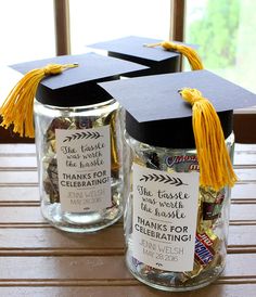 two jars with graduation caps and candy in them