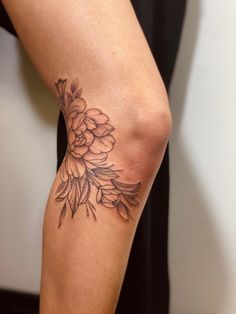 a woman's leg with a flower tattoo on her left arm and right leg