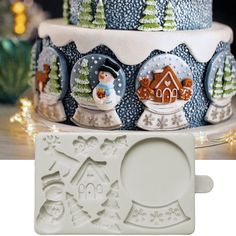 a cake with frosting and decorations on it next to a cookie mold that is shaped like a snowman