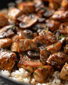 chicken and mushrooms on rice in a skillet