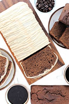 slices of chocolate cake with frosting on plates and coffee beans next to it, along with other desserts