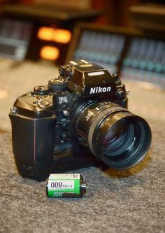 a camera sitting on top of a counter next to a battery