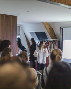 a woman standing in front of a group of people