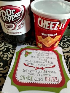 two ice cream cups sitting on top of a table next to a sign that says, snack and drink