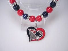 a red, white and blue beaded bracelet with a heart charm