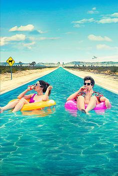 two women sitting on inflatable rafts floating down a long stretch of water