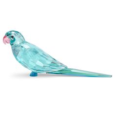 a glass bird sitting on top of a table