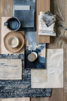 an assortment of blue and white items laid out on a wooden table with napkins