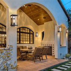 an outdoor dining area with table and chairs