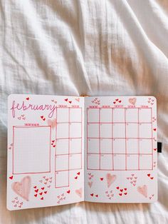 an open planner with hearts on it and the word february written in pink ink, is laying on a white sheet