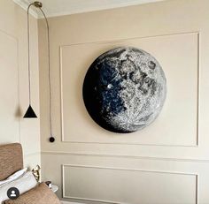 the moon is hanging on the wall in this bedroom