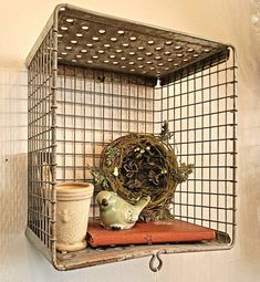 an old metal shelf with a teapot and cup on it, next to a wire basket