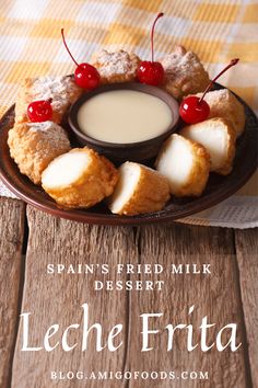 a plate filled with cookies and cream on top of a wooden table next to a glass of milk