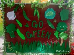 a sign that says go green with vegetables and leaves on it in front of some plants