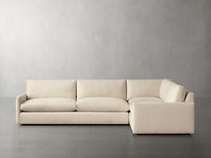 a white couch sitting on top of a gray floor