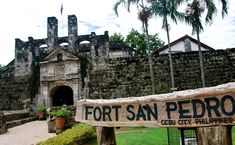 the fort san pedro sign is posted in front of an old building