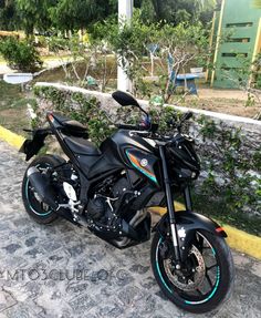 a black motorcycle parked on the side of a road