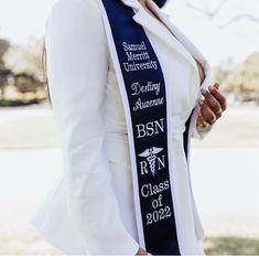 a woman wearing a sash with the names of her graduates