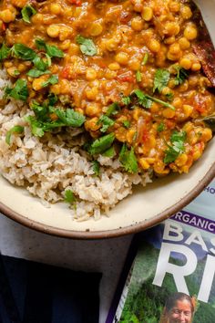 a bowl filled with rice, beans and cilantro on top of a magazine