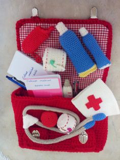 a red case filled with medical items on top of a table