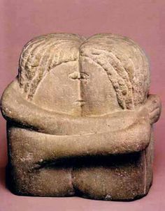 a stone statue with two hands on it's face and arms wrapped around each other