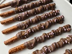 chocolate covered pretzels are lined up on a plate