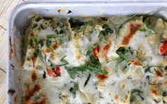 a casserole dish with spinach and cheese