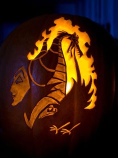 a carved pumpkin with an image of a woman's head on it and flames in the background