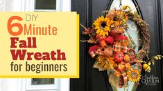 a wreath with sunflowers and fall leaves on it is displayed in front of a door