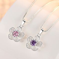 Add some playful charm with this Cute Cherry Blossom Necklace featuring a dainty design and a choice between a pink or purple gem. Its beauty and uniqueness will have you feeling stunning and blooming with confidence. (Plus, it's so cute you'll want to wear it every day!) 🌸Description: Product Type: Necklace Modeling: Flower Product Material: S925 + High Quality Zircon Product Size: Pendant height is about 17mm. Width is about 12mm. Color: 925 sterling silver pink water-containing glass chain. Cherry Blossom Necklace, Purple Gems, Peach Blossom, Purple Necklace, Women's Jewelry Sets, Pendent Necklace, Peach Blossoms, Floral Necklace, Necklaces For Women