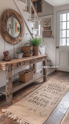 a wooden table sitting under a stair case next to a mirror and potted plant