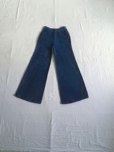 "1970s high waist bell bottom blue jeans cotton zip fly  button snap 2 front pockets authentic age wear aged patina w/fade streaks red, white, blue stitching label size 13/14 (much smaller, see below) measures, lying flat, waist- 13\" to 13 1/2\" with a tug  rise-12\" inseam-31\" hem-13\" hip-21\" total length-42\"     We do not offer returns or refunds unless something is grossly misrepresented. Please contact us within 2 business days of receiving to discuss any possible returns for this reason. We do not offer refunds for your shipping fees. Please feel free to contact us with any questions you may have about an item prior to purchase and we will gladly answer them." Blue Cotton Wide Leg Flares, Vintage Washed Blue Bottoms For Fall, Fitted Wide Leg Washed Blue Flare Jeans, Vintage Dark Wash Pants For Fall, Fitted Wide Leg Flare Jeans In Washed Blue, Washed Blue Fitted Wide-leg Flare Jeans, Fitted Wide-leg Washed Blue Flare Jeans, Dark Wash Full Length Cotton Flares, Full-length Dark Wash Cotton Flares