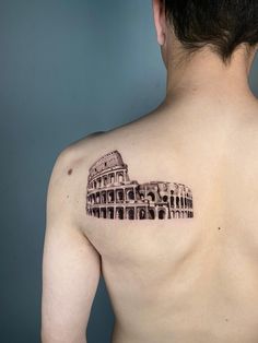 a man with a tattoo on his back that has the image of an ancient building