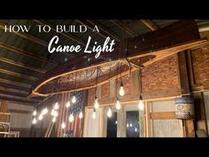 a light fixture hanging from the ceiling in a room with wood paneling and lights