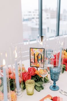 the table is set with flowers and candles