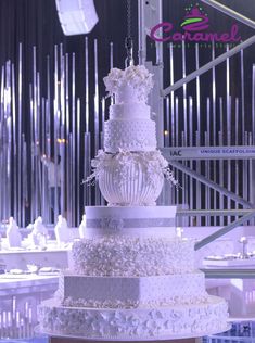 a large white wedding cake sitting on top of a table