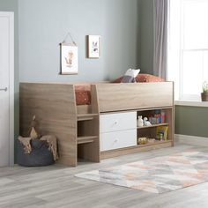 a child's bedroom with a bed, dresser and rug