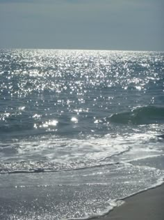 the sun shines on the water at the beach