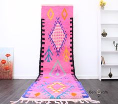 a pink and blue rug is on the floor