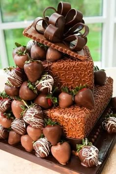 chocolate covered strawberries are stacked on top of each other in this unusual cake design