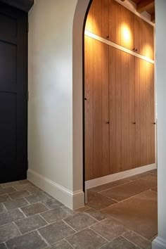 an empty room with wood paneling and two lights on the side of the wall