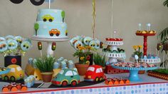 a table topped with lots of cakes and cupcakes