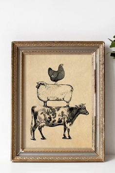 a framed photo with an animal and chicken on it's back, sitting next to a potted plant