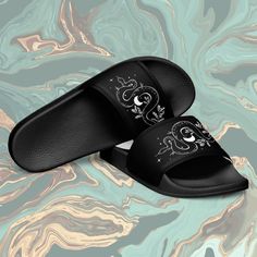 Go full on summer goth with these Snake Moon slides 🌙🦇 * Cushioned and durable faux leather upper strap * Lightweight polyurethane (PU) outsole * Contoured, textured footbed * Stitched around the upper perimeter for extra durability * Spot clean only * Printed, cut, and handmade Black Open Toe Slippers For Streetwear, Adjustable Black Flip Flops With Rubber Sole, Adjustable Black Slippers For Spring, Adjustable Black Non-slip Slides, Black Adjustable Non-slip Slides, Synthetic Open Toe Slippers For Streetwear, Adjustable Black Flat Slippers, Black Adjustable Flat Slippers, Adjustable Black Slip-on Slides