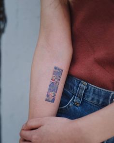 a woman's arm with a small tattoo on the left side of her arm