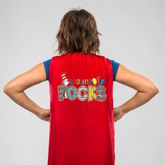 a woman wearing a red vest with the words rock's printed on it, back view